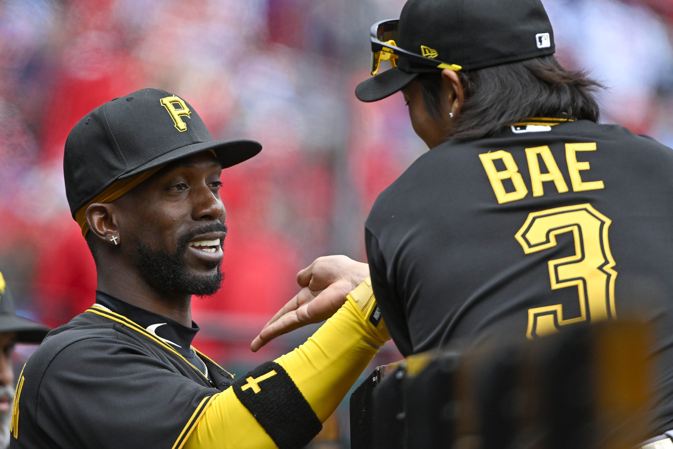 Ji-Hwan Bae and Andrew McCutchen discuss in Pirates dugout