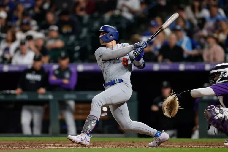 Dodgers right fielder Kiké Hernandez (8) hits a single at Coors Field.