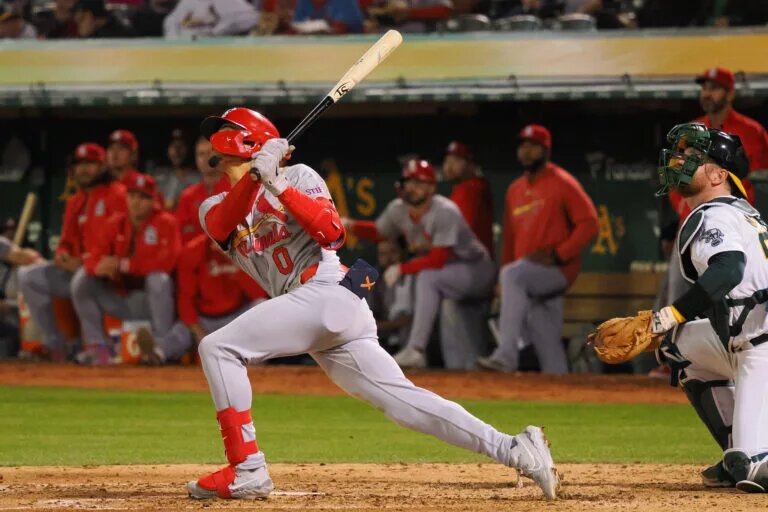 St. Louis Cardinals shortstop Masyn Winn (0) hits a sacrifice fly to score a run against the Oakland Athletics during the sixth inning at Oakland-Alameda County Coliseum.