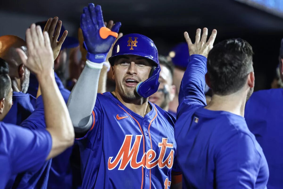 Mets right fielder Tyrone Taylor (15) is greeted in the dugout after hitting a home run.