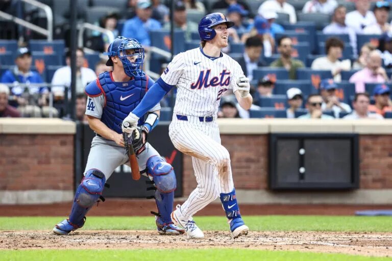 New York Mets third base Brett Baty (22) hits a single in the third inning against the Los Angeles Dodgers at Citi Field in May 2024.