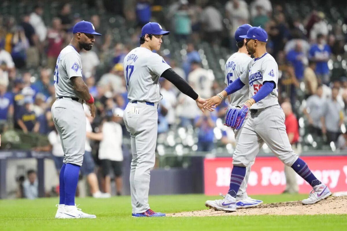 Dodgers shortstop Mookie Betts (50) is greeted by designated hitter Shohei Ohtani (17) following the game against the Milwaukee Brewers at American Family Field in Auguest 2024.