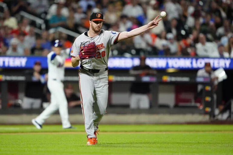 Baltimore Orioles pitcher Trevor Rogers (28) throws out New York Mets right fielder Starling Marte (not pictured) after fielding a bunt during the fourth inning at Citi Field in an August 2024 game.