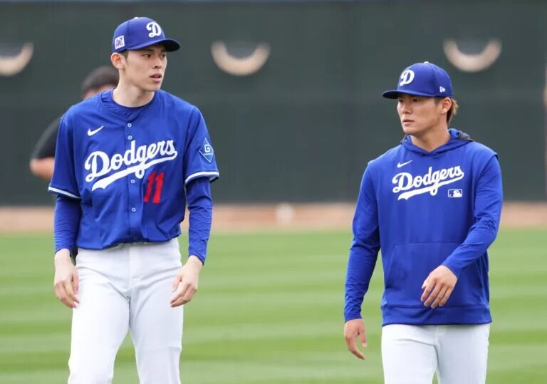 Dodgers manager Dave Roberts said he expects the team's two Japanese starters, Roki Sasaki (left) and Yoshinobu Yamamoto (right) to pitch in the team's opening series in Tokyo.