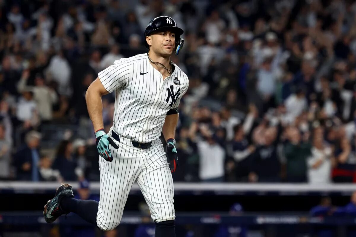 New York Yankees designated hitter Giancarlo Stanton (27) reacts after hitting a home run during the third inning against the Los Angeles Dodgers in game five of the 2024 World Series at Yankee Stadium.