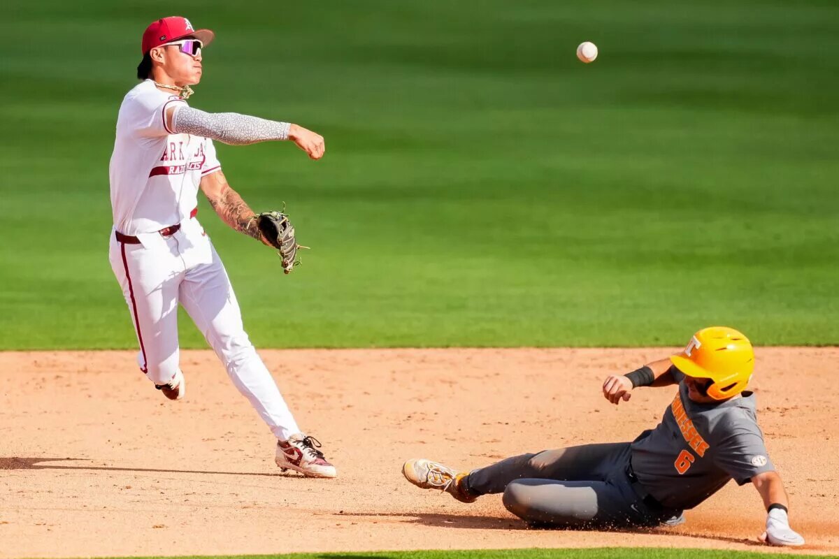 Arkansas shortstop Wehiwa Aloy, now an Orioles prospect, throws to first base