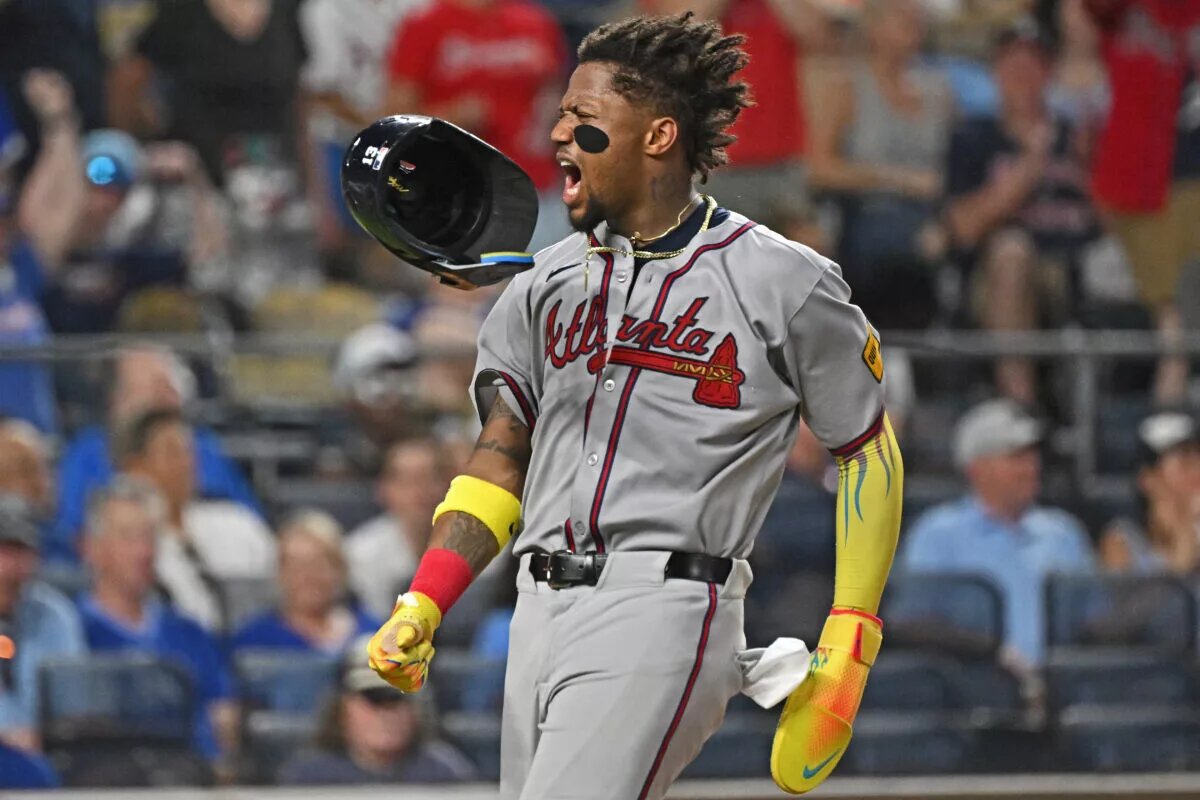 Atlanta Braves right fielder Ronald Acuna Jr. (13) loses his helmet after scoring a run in the eighth inning against the Kansas City Royals at Kauffman Stadium in a July 2025 game.
