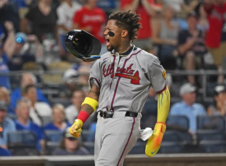 Atlanta Braves right fielder Ronald Acuna Jr. (13) loses his helmet after scoring a run in the eighth inning against the Kansas City Royals at Kauffman Stadium in a July 2025 game.