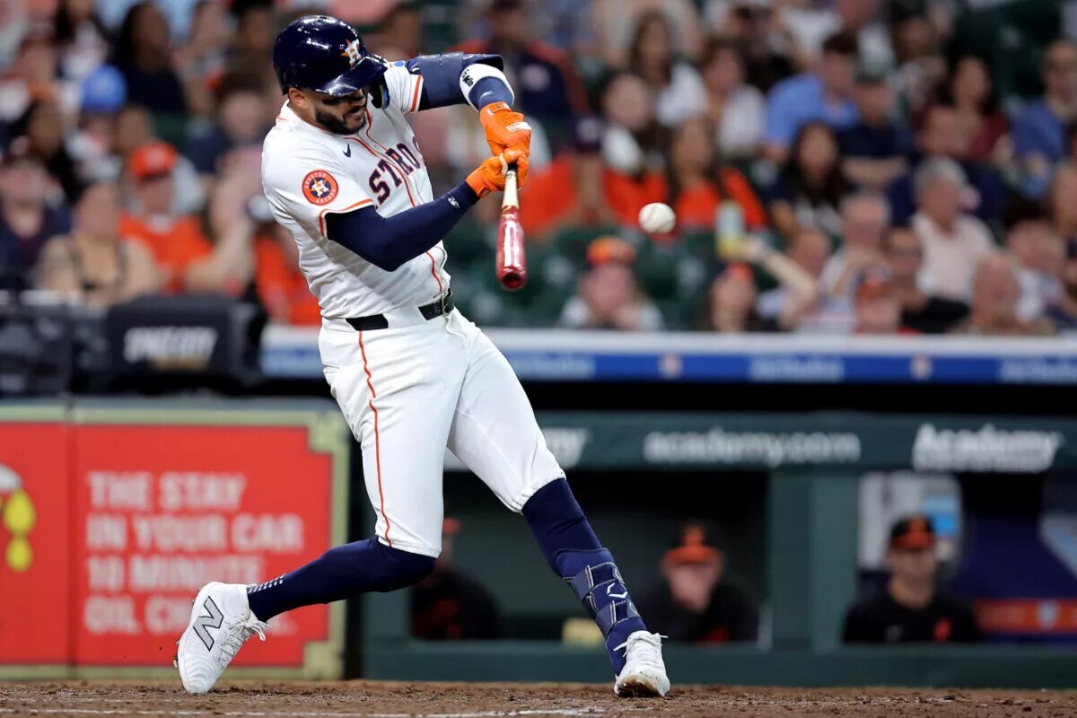 Carlos Correa (1) hits an RBI single at Daikin Park.
