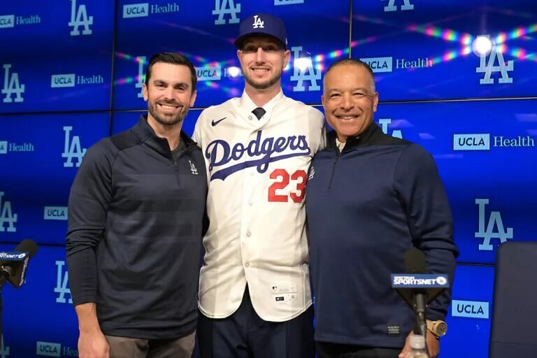 Dodgers general manager Brandon Gomes and manager Dave Roberts (30) stand with newly signed right fielder Kyle Tucker (23) at Dodger Stadium.