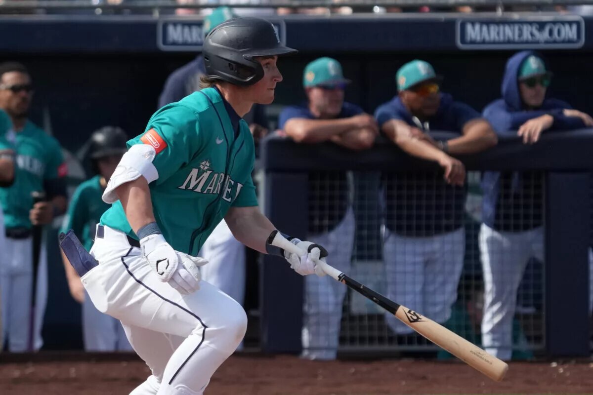 Mariners shortstop Colt Emerson (85) hits a single against the Cleveland Guardians in the second inning at Peoria Sports Complex during 2026 spring training.