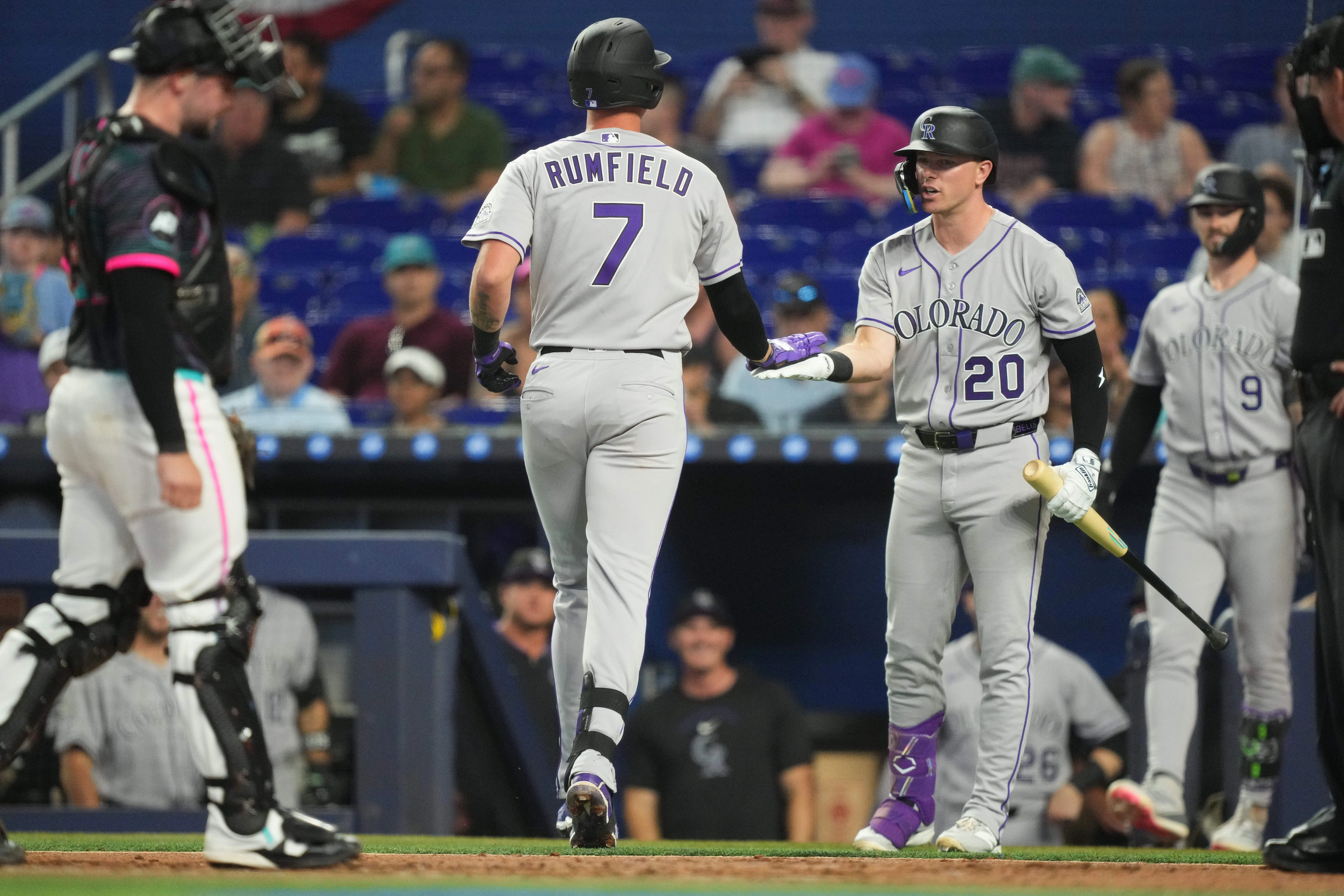 Colorado Rockies first baseman TJ Rumfield being greeted by teammate Troy Johnston after hitting a solo home run in the second inning against the Miami Marlins at LoanDepot Park in Miami, Florida, on March 28, 2026.