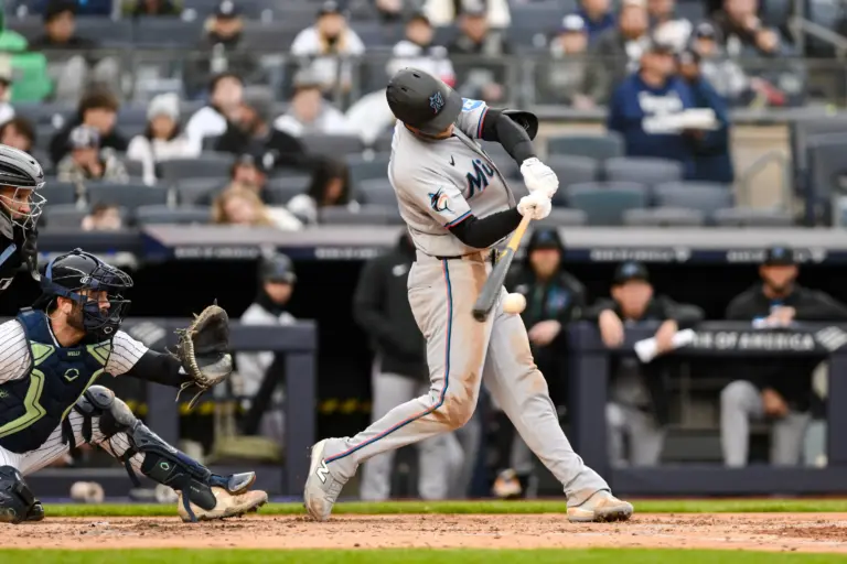 Miami Marlins left fielder Austin Slater (15) hits a single against the New York Yankees during the third inning at Yankee Stadium in an April 2026 game.