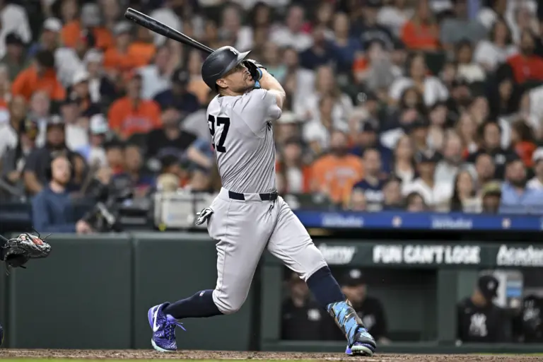 Giancarlo Stanton (27) hits the ball in the third inning against the Houston Astros at Daikin Park.