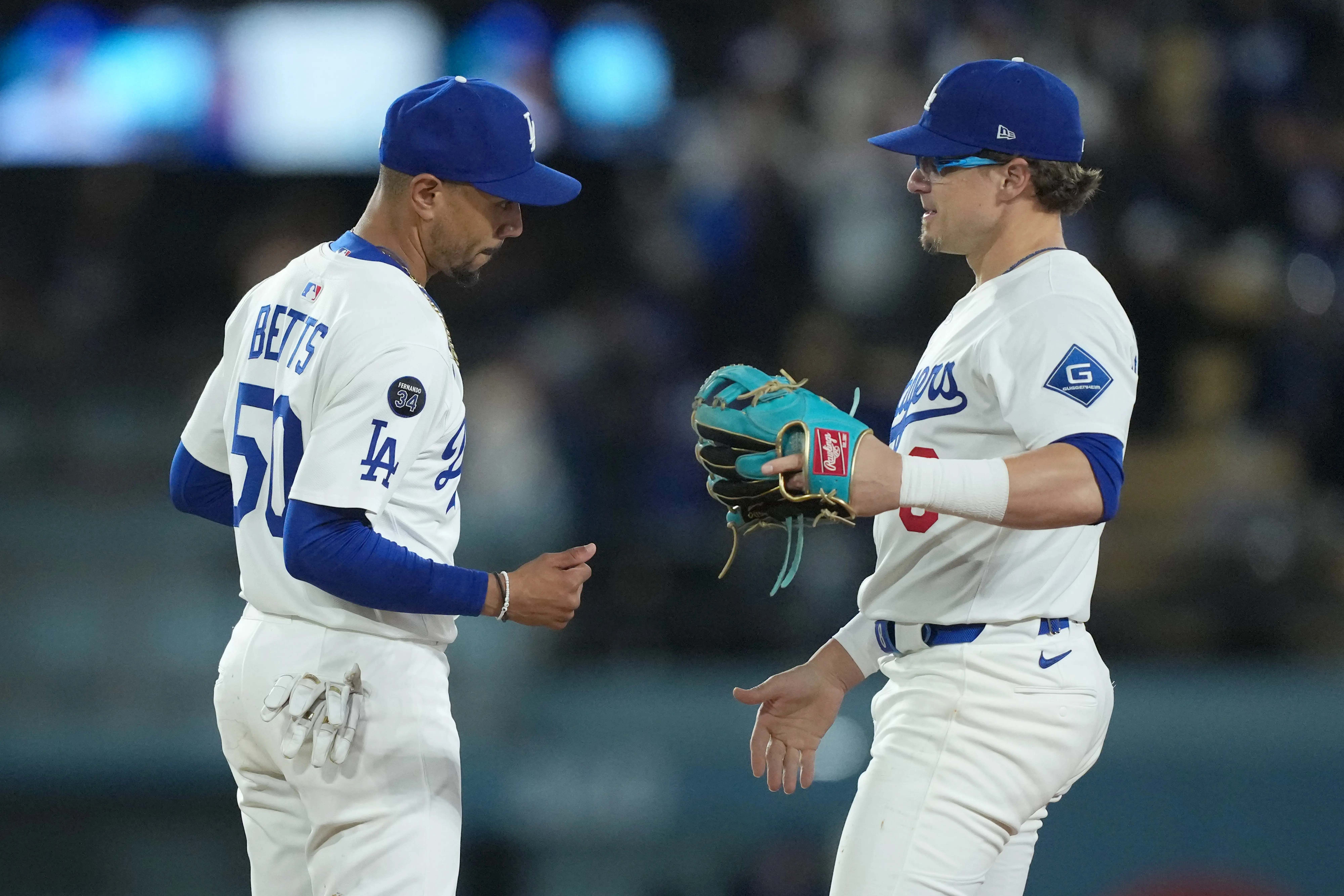 Los Angeles Dodgers shortstop Mookie Betts and second baseman Kike Hernandez celebrate after a win against the Colorado Rockies at Dodger Stadium in Los Angeles, California on April 14, 2025.