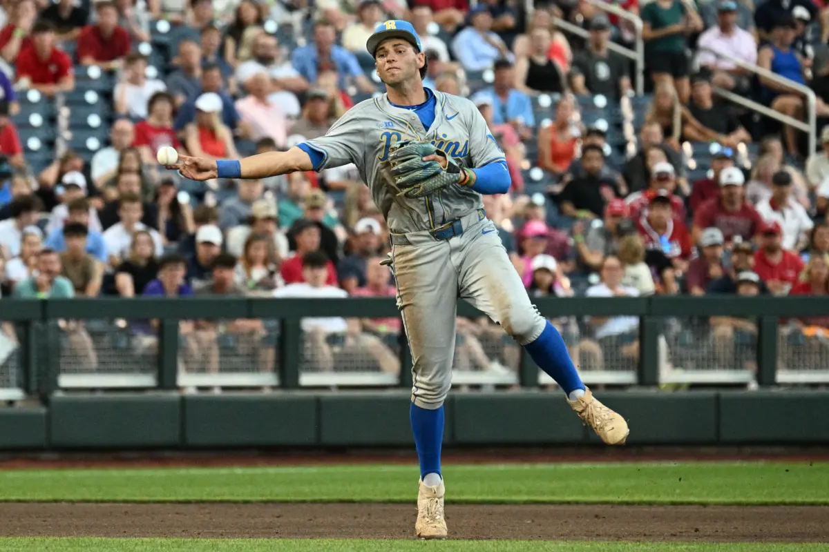 UCLA Bruins shortstop Roch Cholowsky throwing to first base against the Arkansas Razorbacks during the first inning in the College World Series at Charles Schwab Field in Omaha, Nebraska on June 17, 2025.