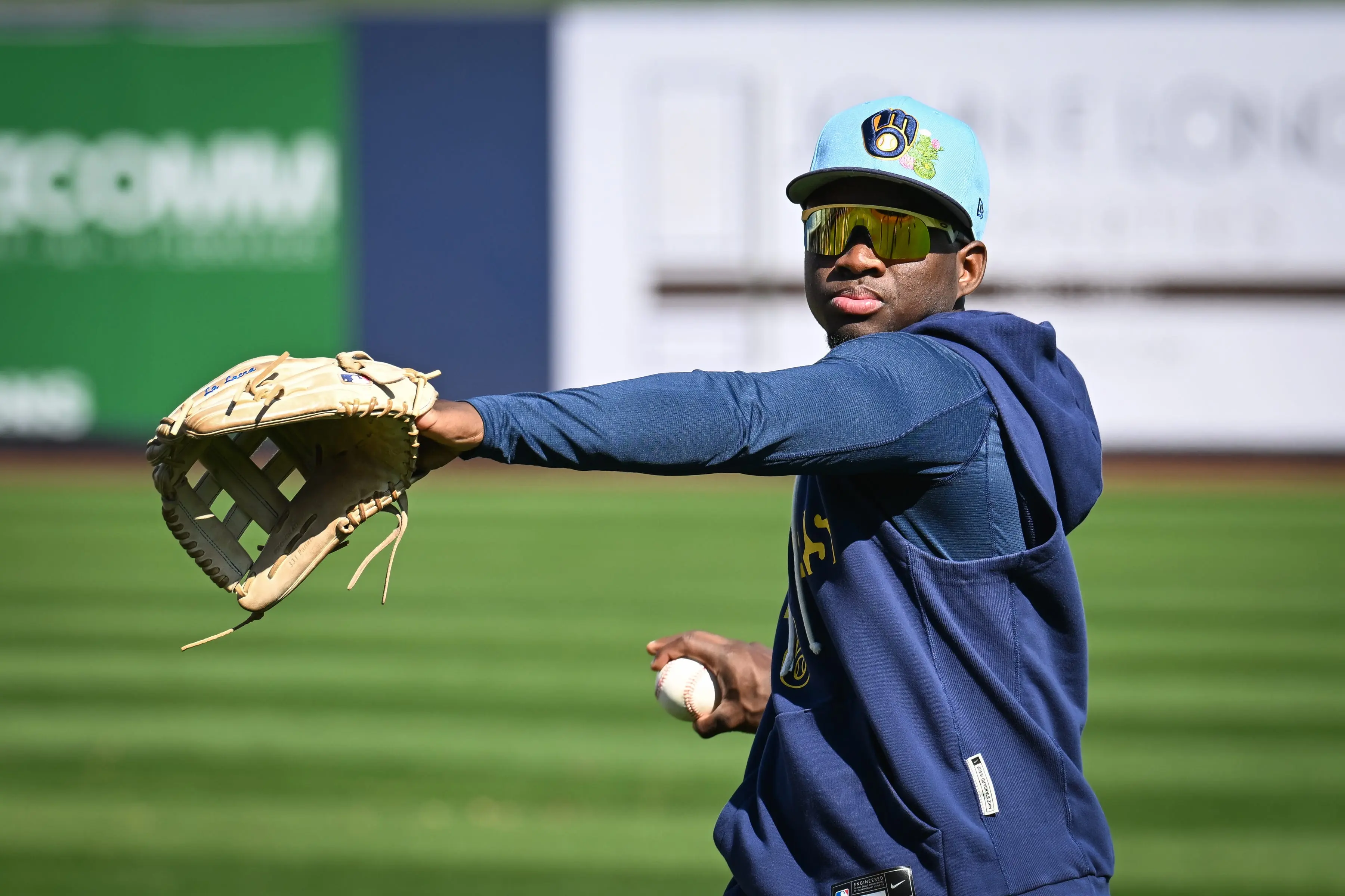 Brewers outfielder Luis Lara plays catch during spring training workouts 