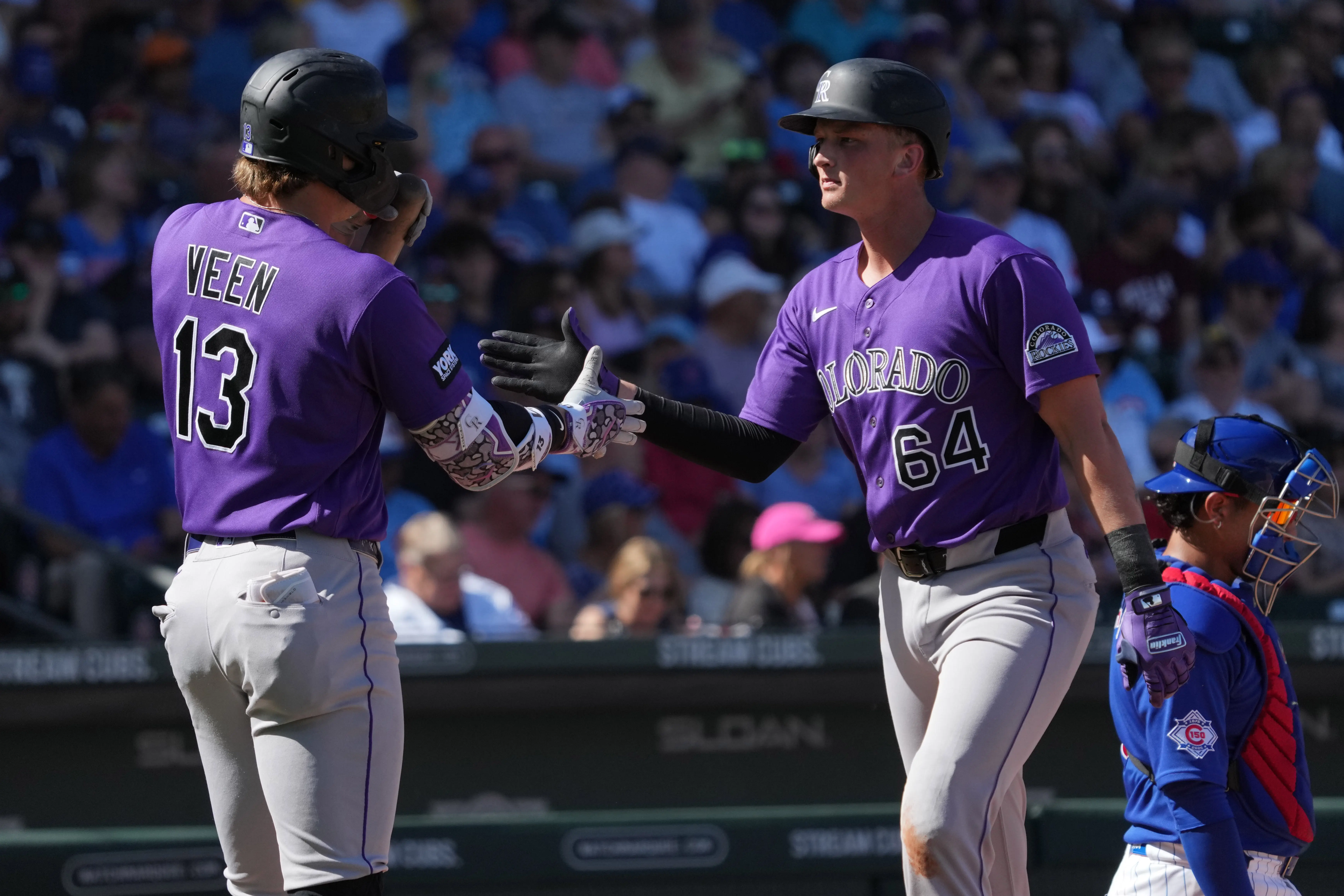 Colorado Rockies first baseman TJ Rumfield celebrates with left fielder Zac Veen after hitting a solo home run during Spring Training vs the Chicago Cubs in the second inning at Sloan Park in Mesa, Arizona on February 25, 2026.