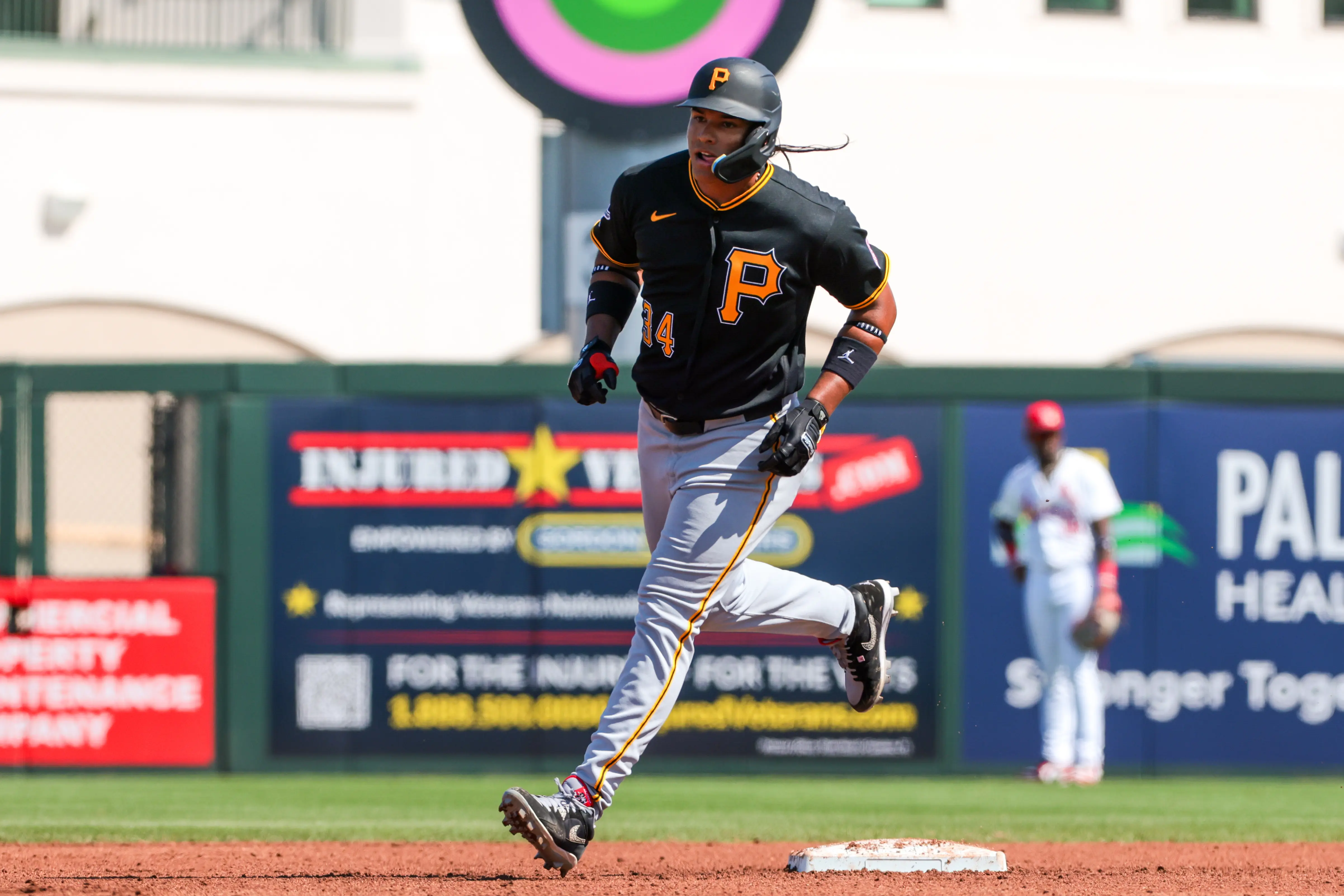 Pirates left fielder Jhostynxon Garcia (34) rounds the bases after hitting a home run against the St. Louis Cardinals during the fourth inning at Roger Dean Chevrolet Stadium.