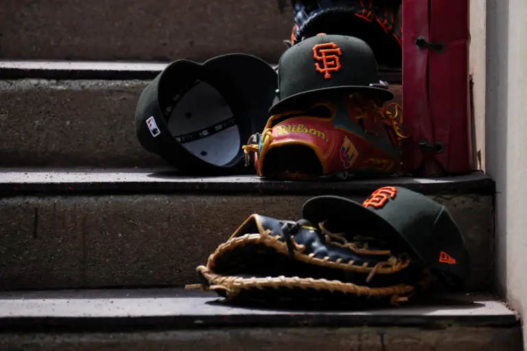 San Francisco Giants hats on the dugout steps during a game between the Cincinnati Reds and San Francisco Giants on April 16, 2026, in Cincinnati, Ohio.
