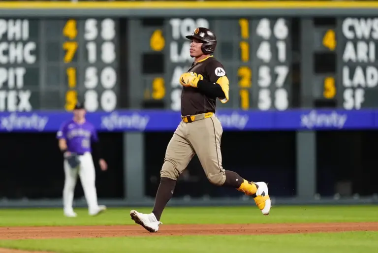 Padres catcher Freddy Fermin (54) doubles in the eighth inning against the Colorado Rockies at Coors Field in April 2026.
