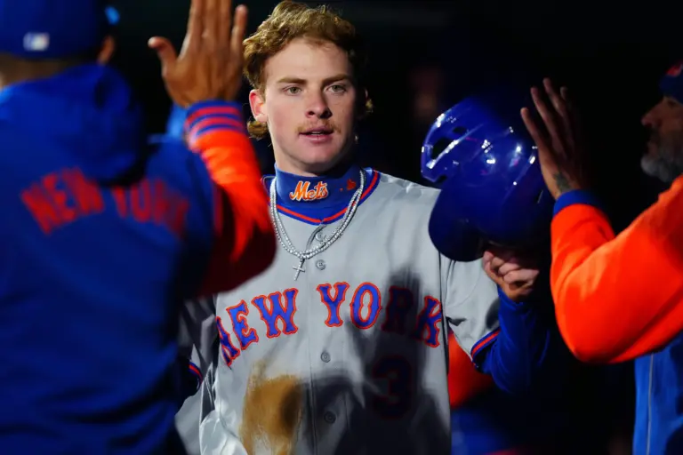 New York Mets center fielder Carson Benge celebrating with teammates in the Mets' dugout following scoring a run against the Colorado Rockies in the fourth inning at Coors Field in Denver, Colorado on May 6, 2026.