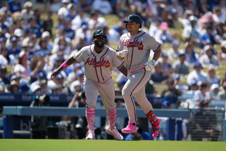 Atlanta Braves designated hitter Drake Baldwin (30) is congratulated by third base coach Tommy Watkins (84) after hitting a home run in the eighth inning against the Los Angeles Dodgers at Dodger Stadium.