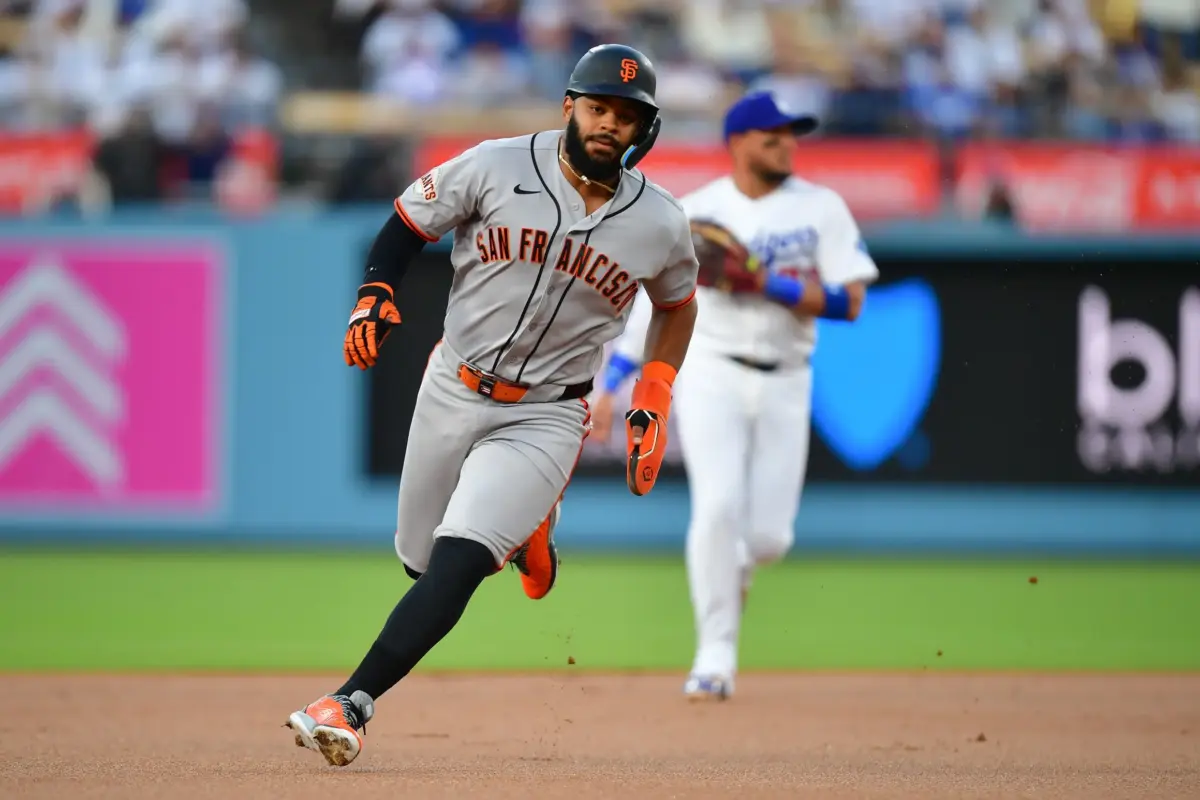 Giants left fielder Heliot Ramos (17) runs to third base in the first inning against the Los Angeles Dodgers at Dodger Stadium.