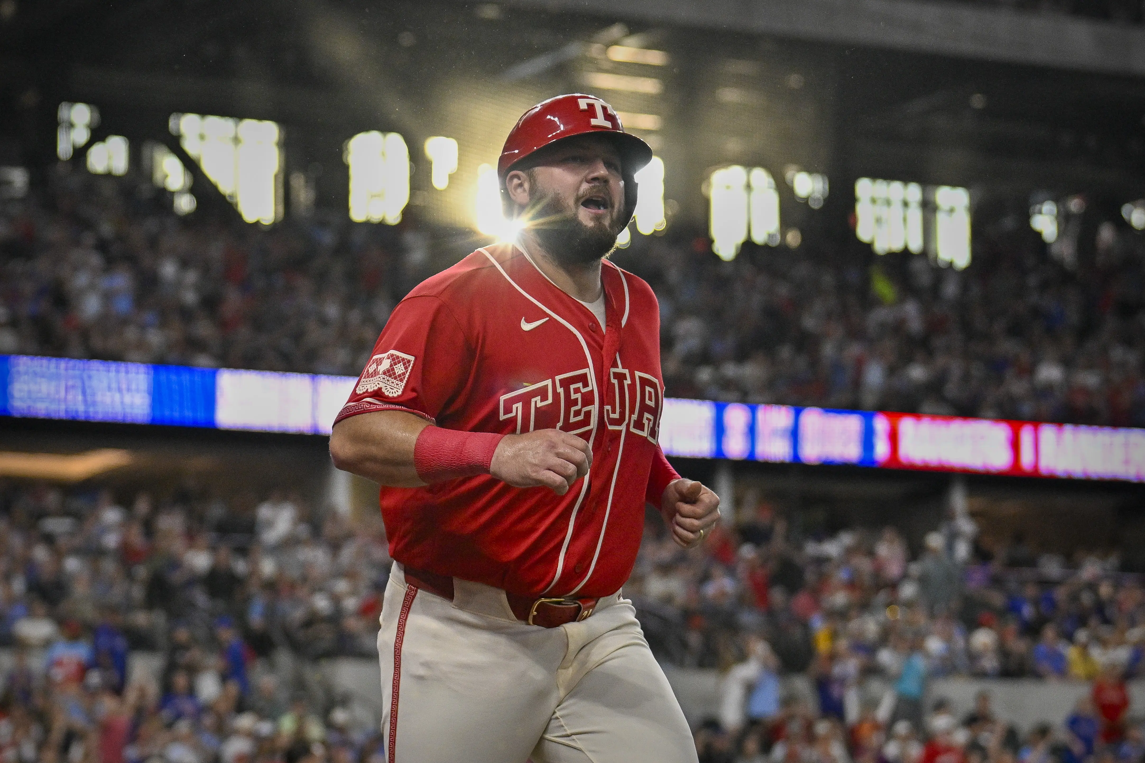 Texas Rangers first baseman Jake Burger coming off the field after scoring a run vs the San Diego Padres during the first inning at Globe Life Field in Arlington, Texas on June 19, 2026.