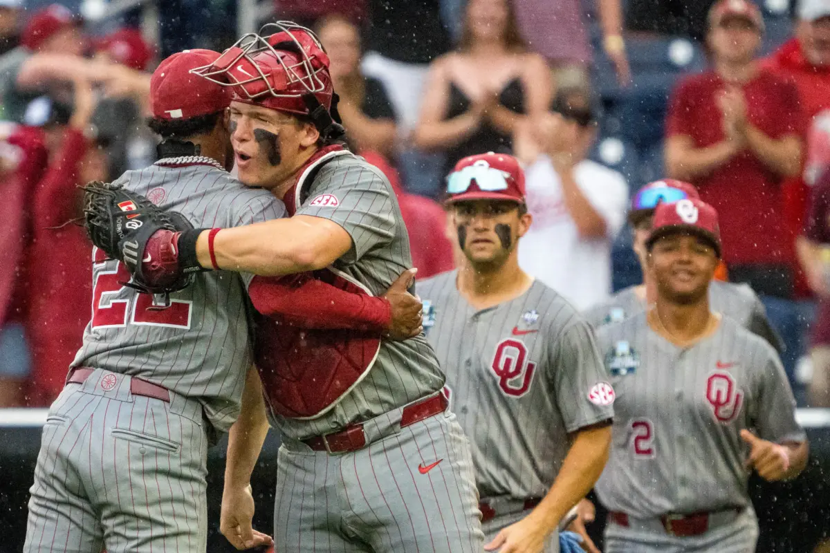 Oklahoma Sooners pitcher LJ Mercurius and catcher Deiten Lachance celebrating after the Sooners defeated the North Carolina Tar Heels 9-3 in game one of the College World Series at Charles Schwab Field in Omaha, Nebraska on June 20, 2026.