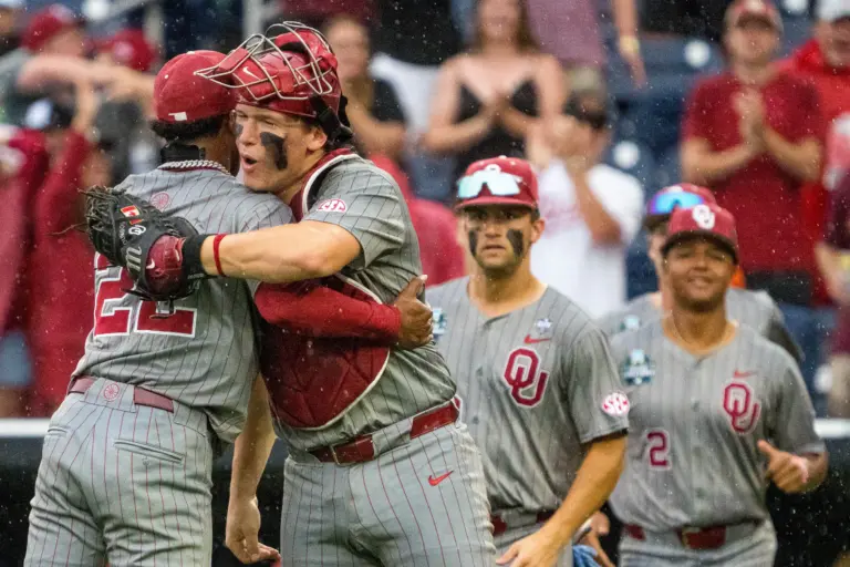 Oklahoma Sooners pitcher LJ Mercurius and catcher Deiten Lachance celebrating after the Sooners defeated the North Carolina Tar Heels 9-3 in game one of the College World Series at Charles Schwab Field in Omaha, Nebraska on June 20, 2026.
