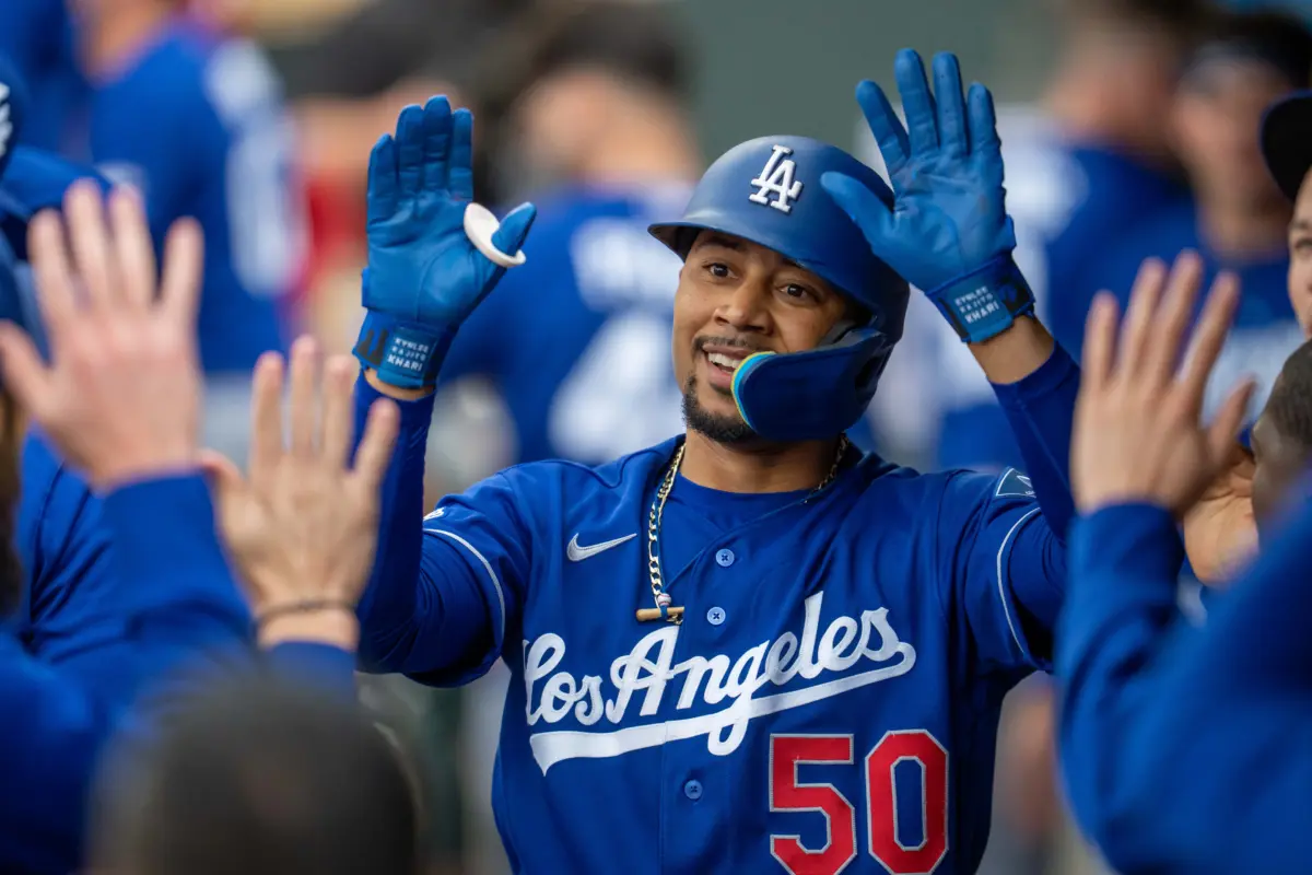 Dodgers shortstop Mookie Betts (50) celebrates with teammates in the dugout after hitting a solo home run against the Minnesota Twins in the first inning at Target Field.