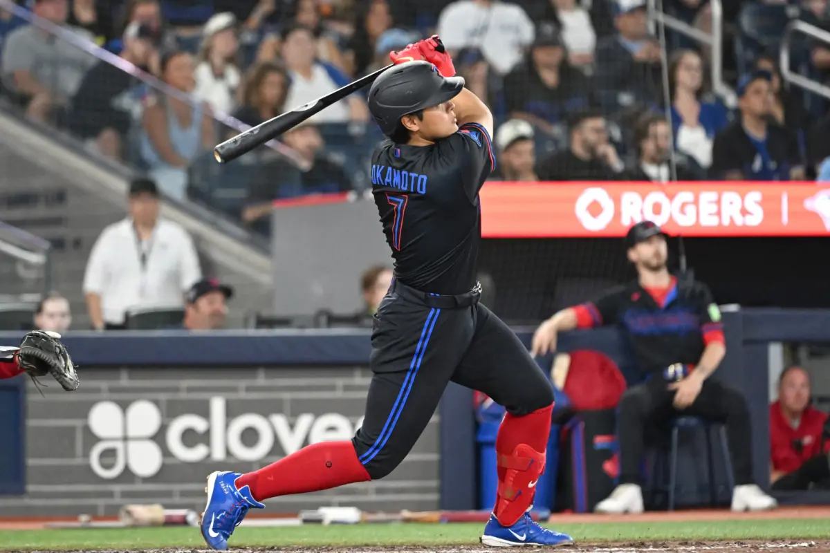Toronto Blue Jays third baseman Kazuma Okamoto hits a two-run home run against the Texas Rangers during the eighth inning at Rogers Centre in Toronto, Ontario, Canada, on June 26, 2026.