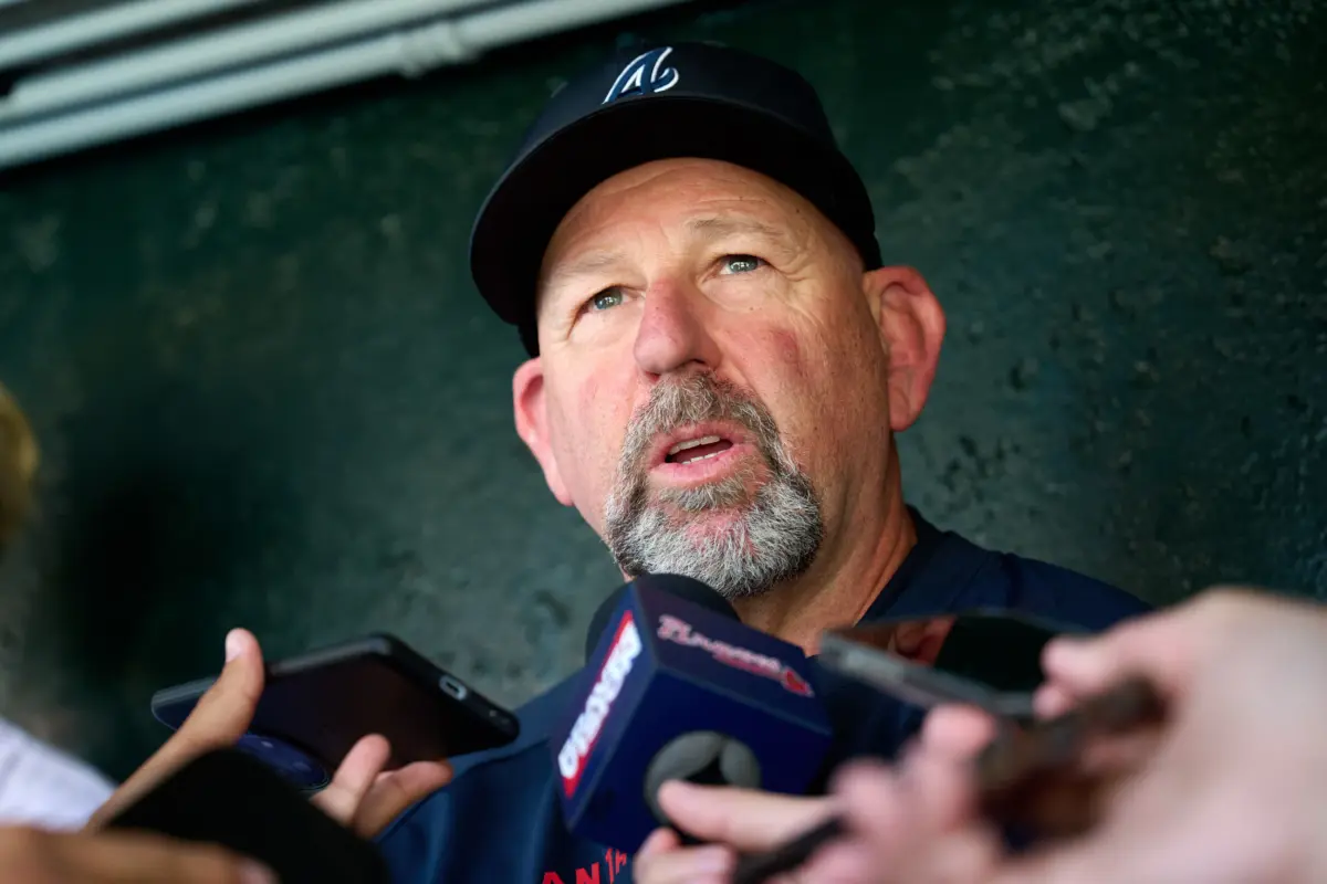 Braves manager Walt Weiss (22) speaks to the media in the dugout before a game against the San Francisco Giants at Oracle Park.