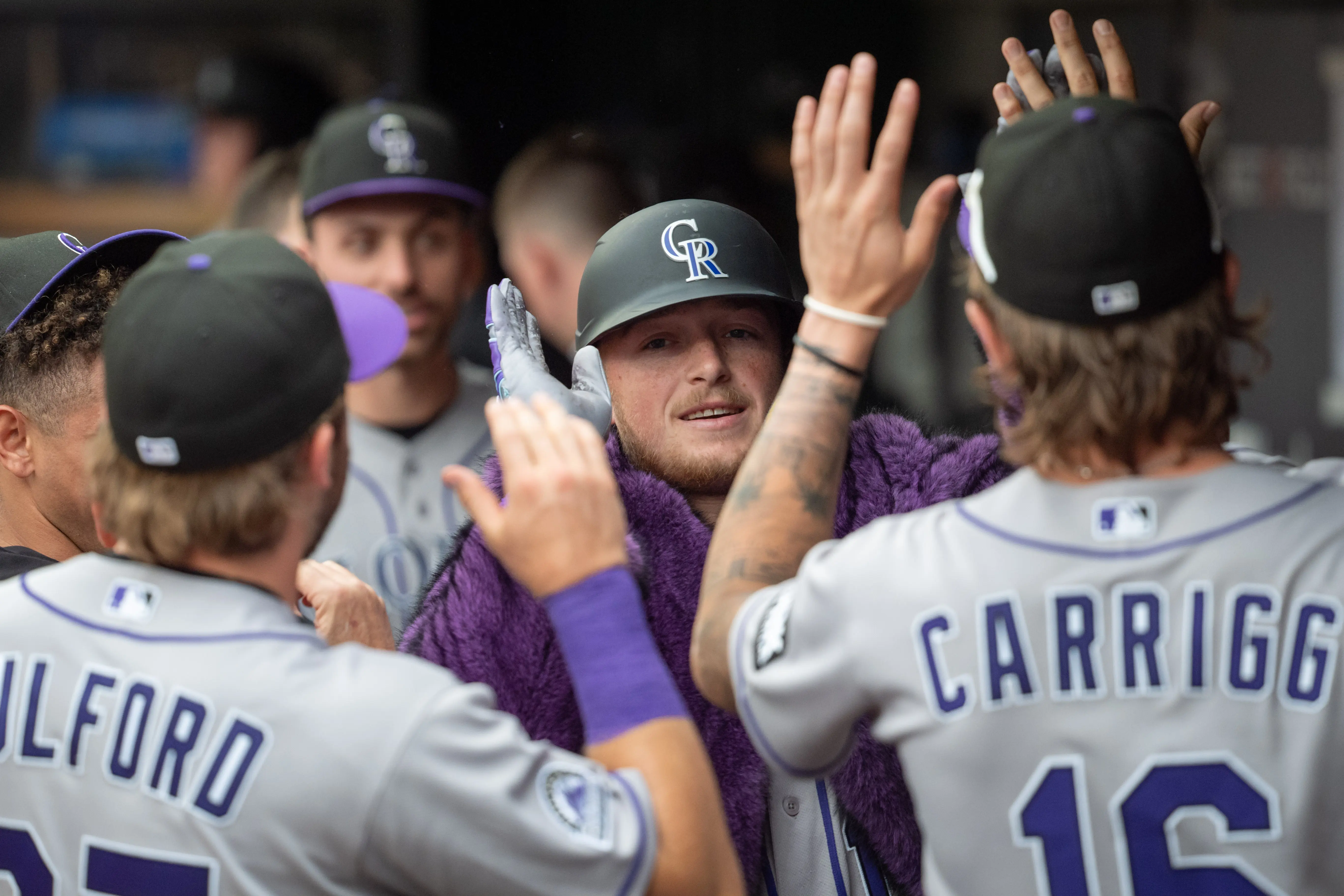Colorado Rockies catcher Hunter Goodman celebrating with teammates in the Rockies' dugout after hitting his second home run of the game vs the Minnesota Twins at Target Field in Minneapolis, Minnesota on June 27, 2026.