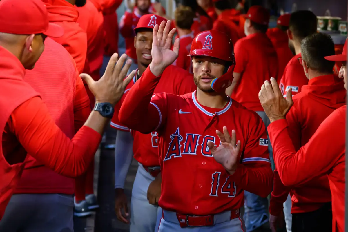 Angels catcher Logan O'Hoppe (14) celebrates in the dugout after scoring a run against the Seattle Mariners during the seventh inning at T-Mobile Park.