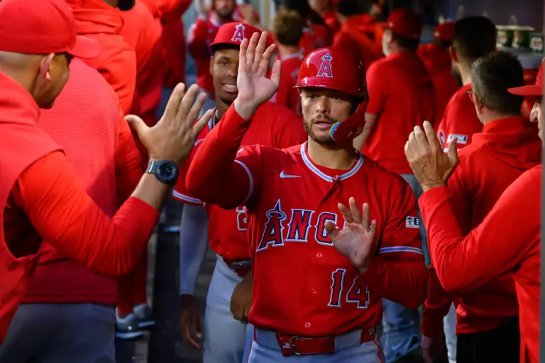 Angels catcher Logan O'Hoppe (14) celebrates in the dugout after scoring a run against the Seattle Mariners during the seventh inning at T-Mobile Park.