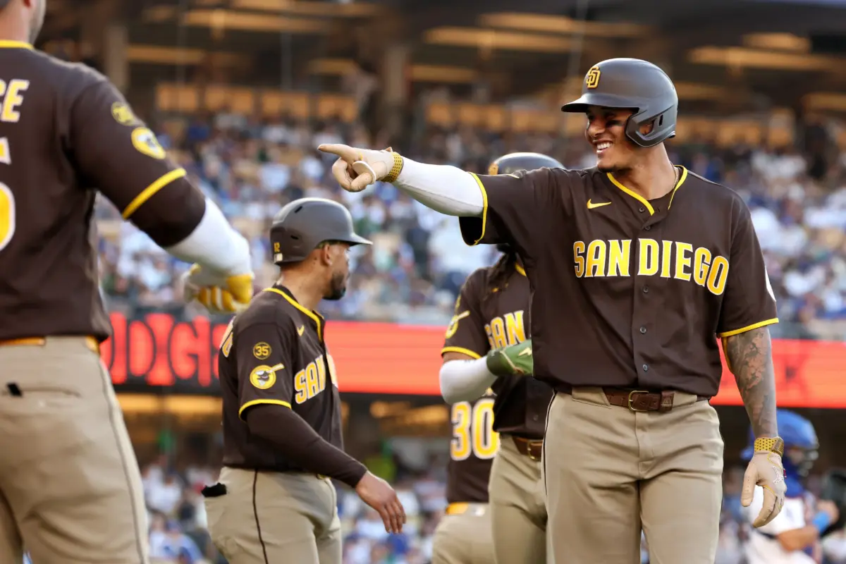 Padres third baseman Manny Machado (13) gestures after he hit a 3-run home run in the seventh inning against the Los Angeles Dodgers at Dodger Stadium.