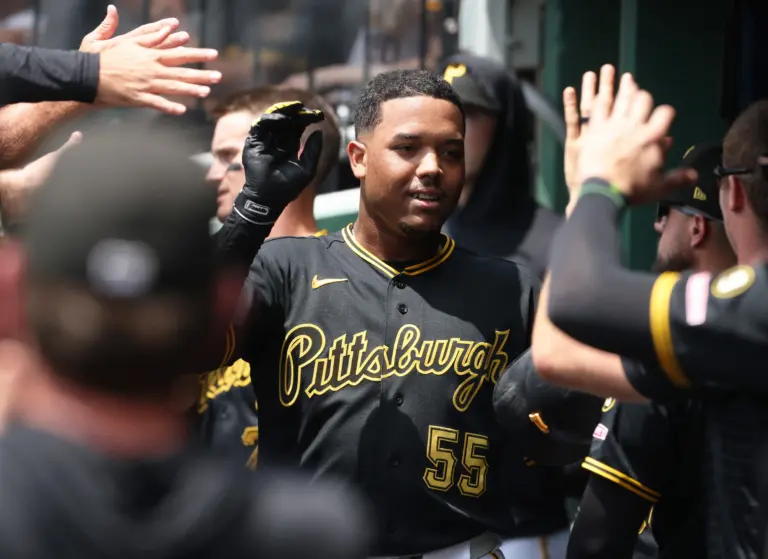 Pittsburgh Pirates right fielder Esmerlyn Valdez celebrating with teammates in dugout.