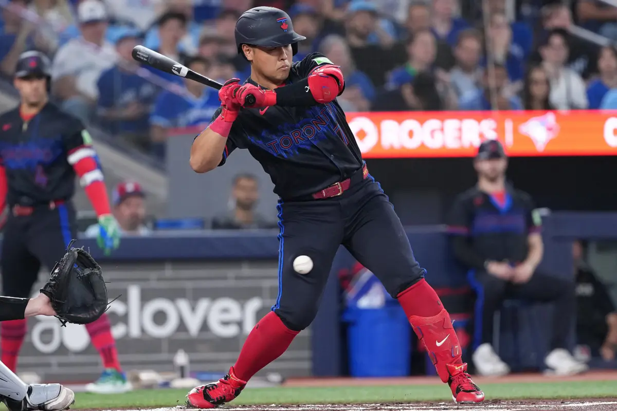 Toronto Blue Jays third baseman Kazuma Okamoto being hit in leg by pitch.