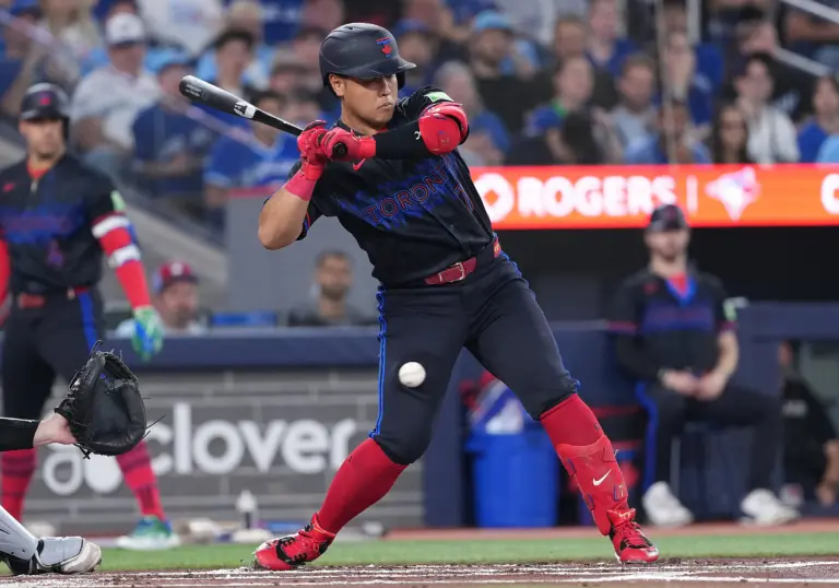 Toronto Blue Jays third baseman Kazuma Okamoto being hit in leg by pitch.