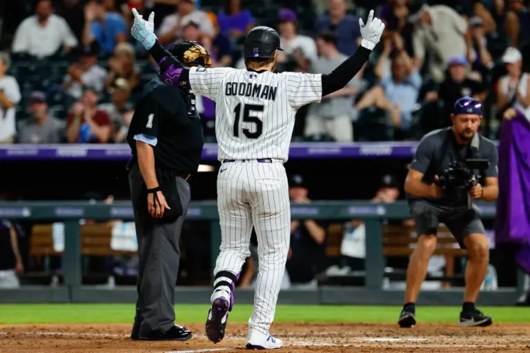 Colorado Rockies catcher Hunter Goodman celebrating before crossing home plate.