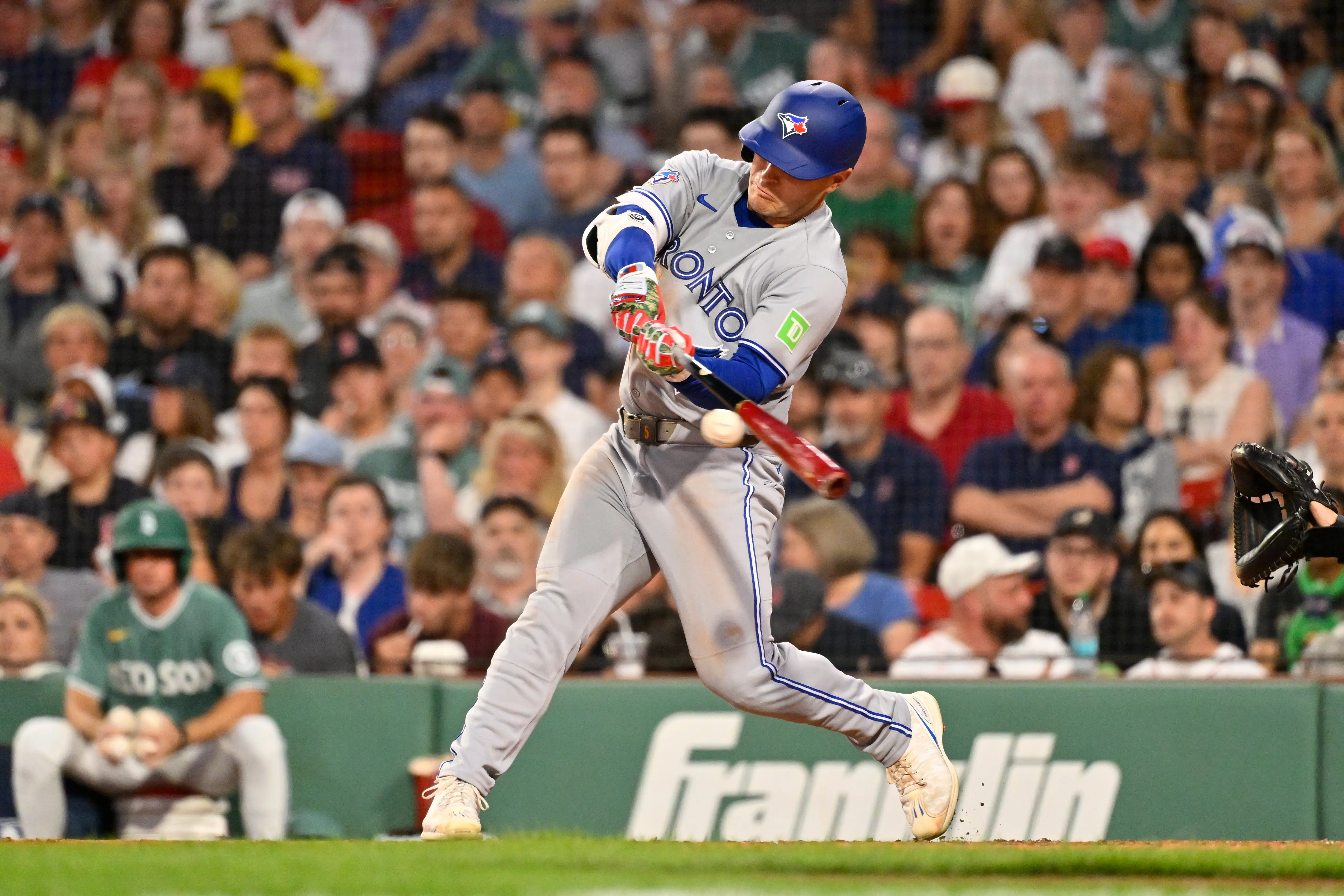 One of the Toronto Blue Jays most valuable trade chips, center fielder Daulton Varsho hitting a single vs the Boston Red Sox.