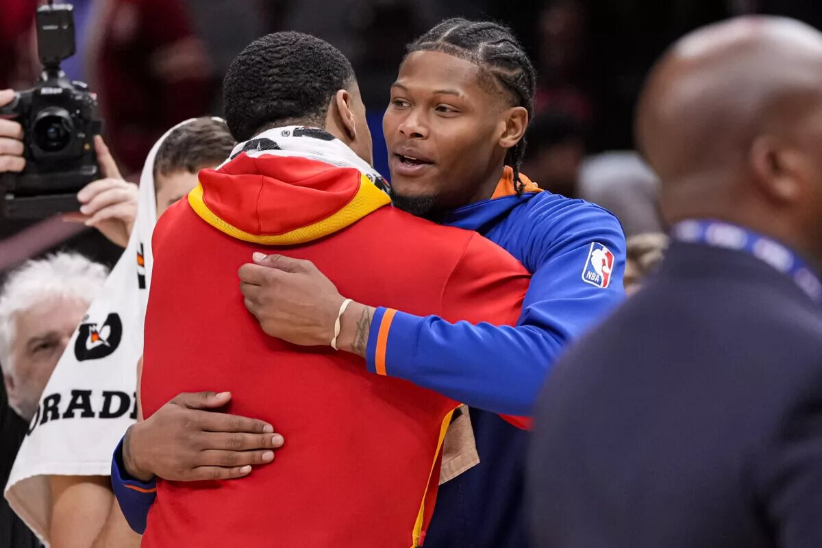 Atlanta Hawks forward John Collins (left) and New York Knicks forward Cam Reddish (right) react together after the Hawks defeated the Knicks at State Farm Arena. Mandatory Credit: Dale Zanine-USA TODAY Sports