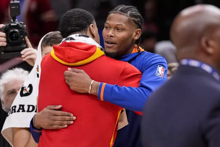 Atlanta Hawks forward John Collins (left) and New York Knicks forward Cam Reddish (right) react together after the Hawks defeated the Knicks at State Farm Arena. Mandatory Credit: Dale Zanine-USA TODAY Sports