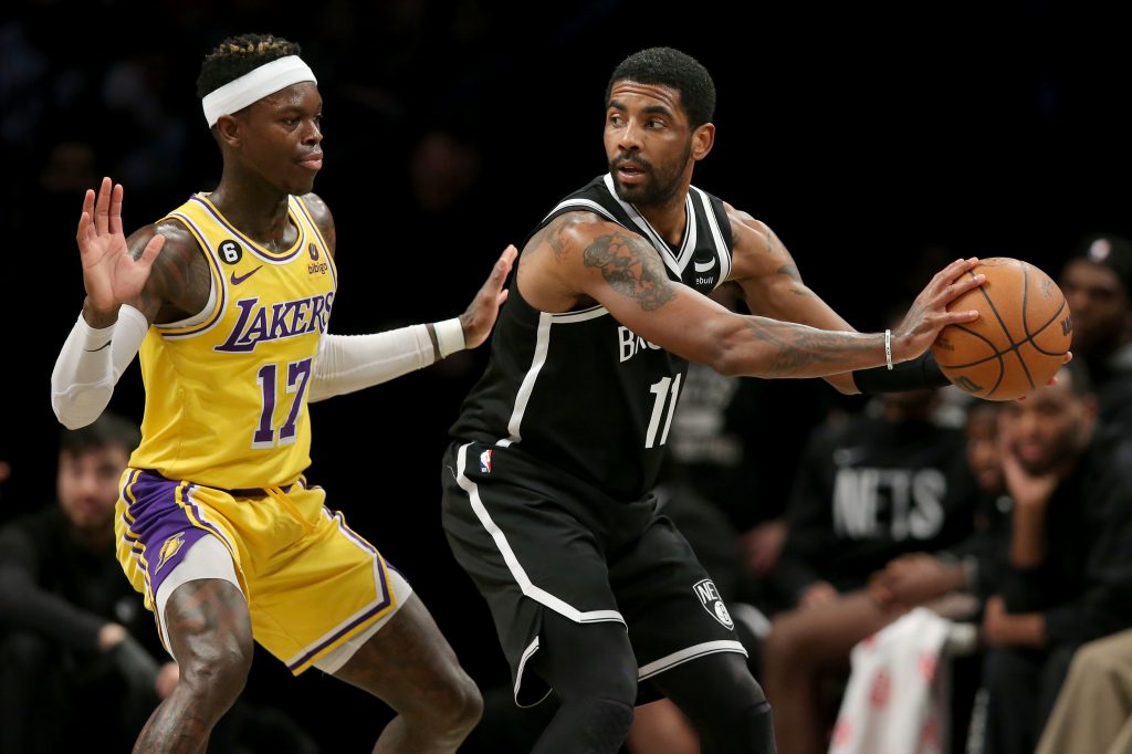 Kyrie Irving (11) controls the ball against Los Angeles Lakers guard Dennis Schroder (17) during the third quarter at Barclays Center. Mandatory Credit: Brad Penner-USA TODAY Sports