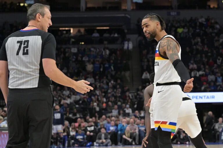 Feb 3, 2023; Minneapolis, Minnesota, USA; Minnesota Timberwolves guard D'Angelo Russell (0) reacts with referee J.T. Orr (72) during the first quarter against the Orlando Magic at Target Center. Mandatory Credit: Jeffrey Becker-USA TODAY Sports