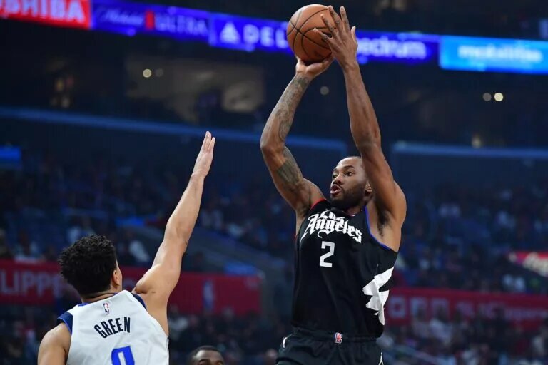 Los Angeles Clippers forward Kawhi Leonard (2) shoots against Dallas Mavericks forward Josh Green (8) during the first half at Crypto.com Arena. Mandatory Credit: Gary A. Vasquez-USA TODAY Sports