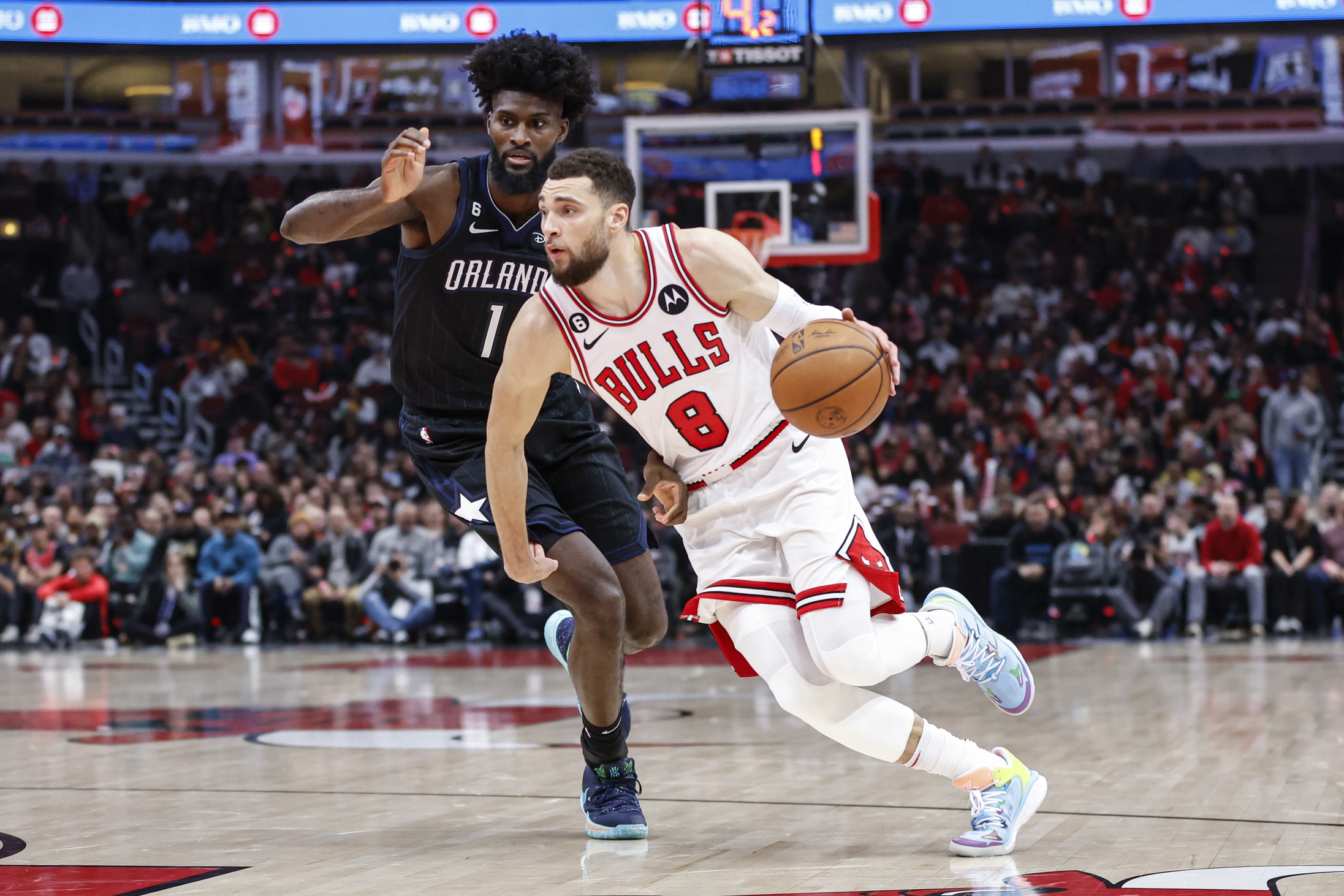 Chicago Bulls guard Zach LaVine (8) drives to the basket against Orlando Magic forward Jonathan Isaac (1) during the first half at United Center. Mandatory Credit: Kamil Krzaczynski-USA TODAY Sports