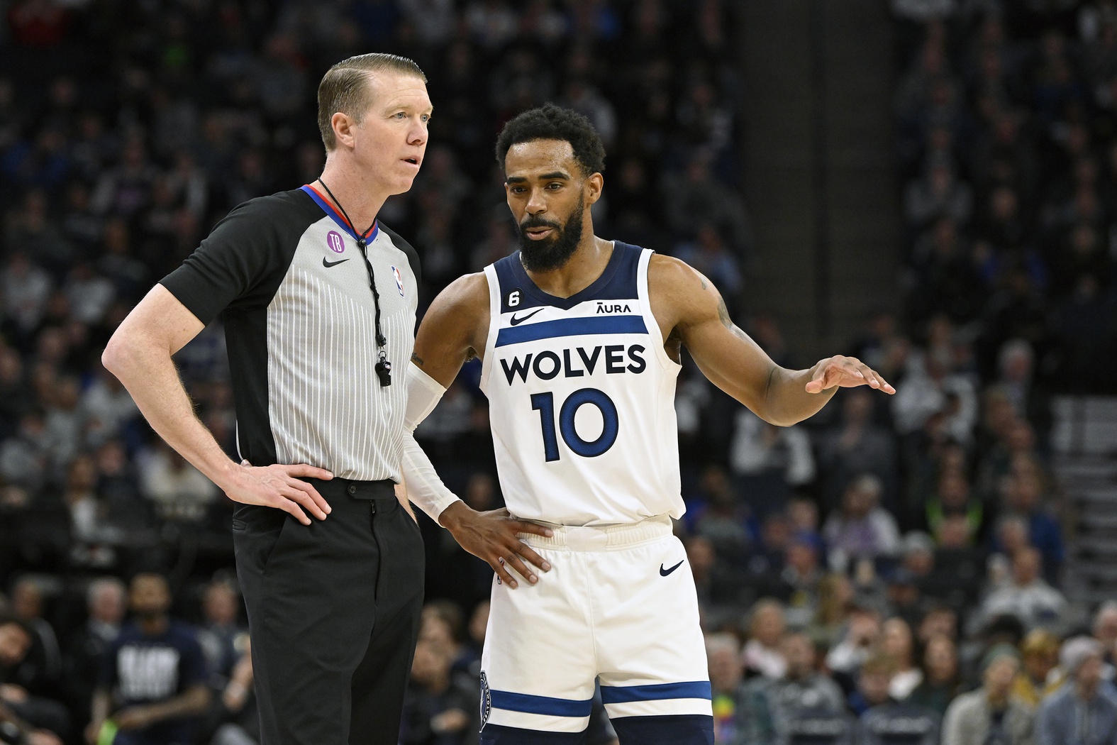 Feb 16, 2023; Minneapolis, Minnesota, USA; Minnesota Timberwolves guard Mike Conley (10) chats with referee Ed Malloy (14) during the fourth quarter of a game against the Washington Wizards at Target Center. Mandatory Credit: Nick Wosika-USA TODAY Sports